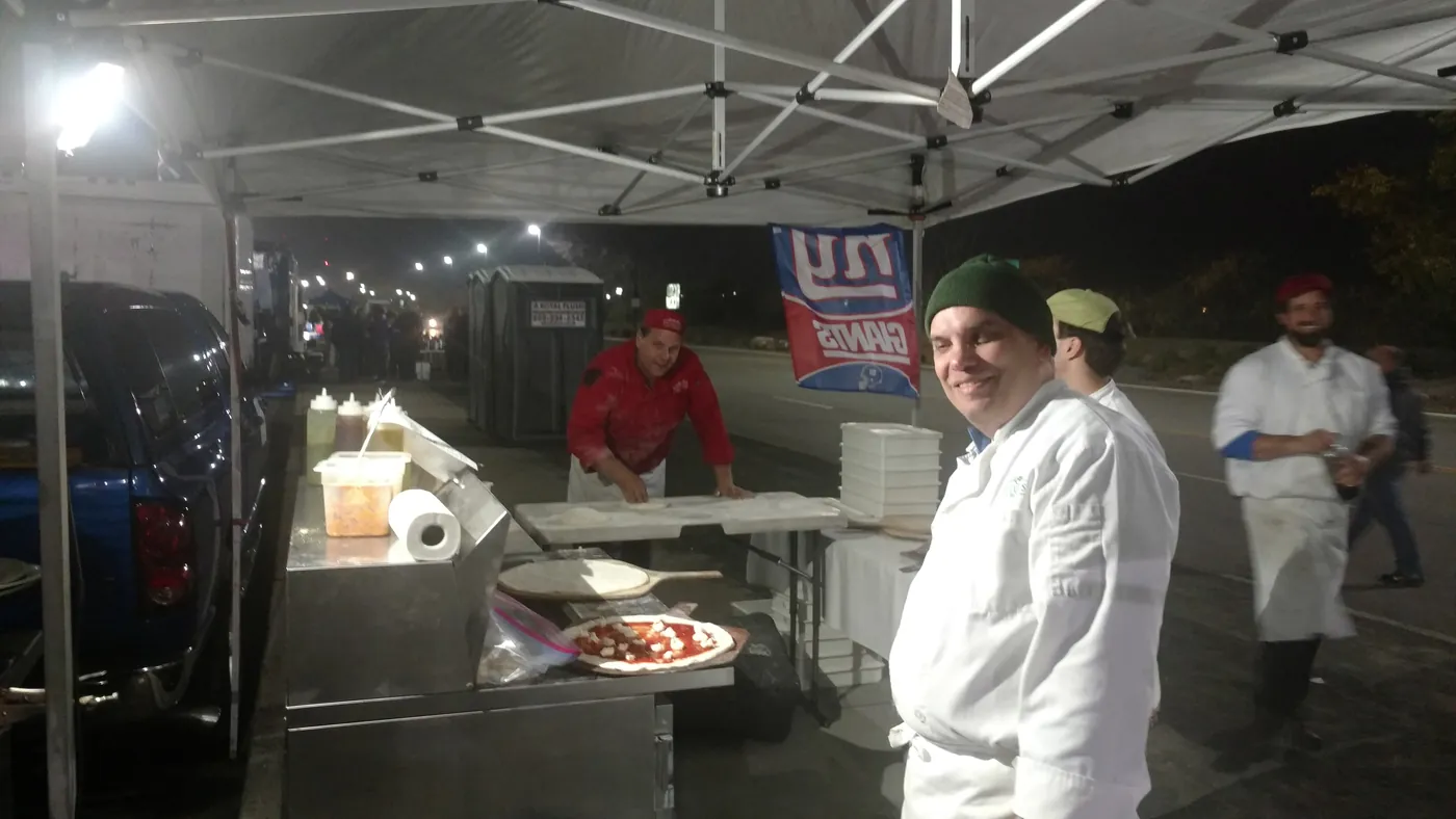 Chefs in white coats running a catering station
