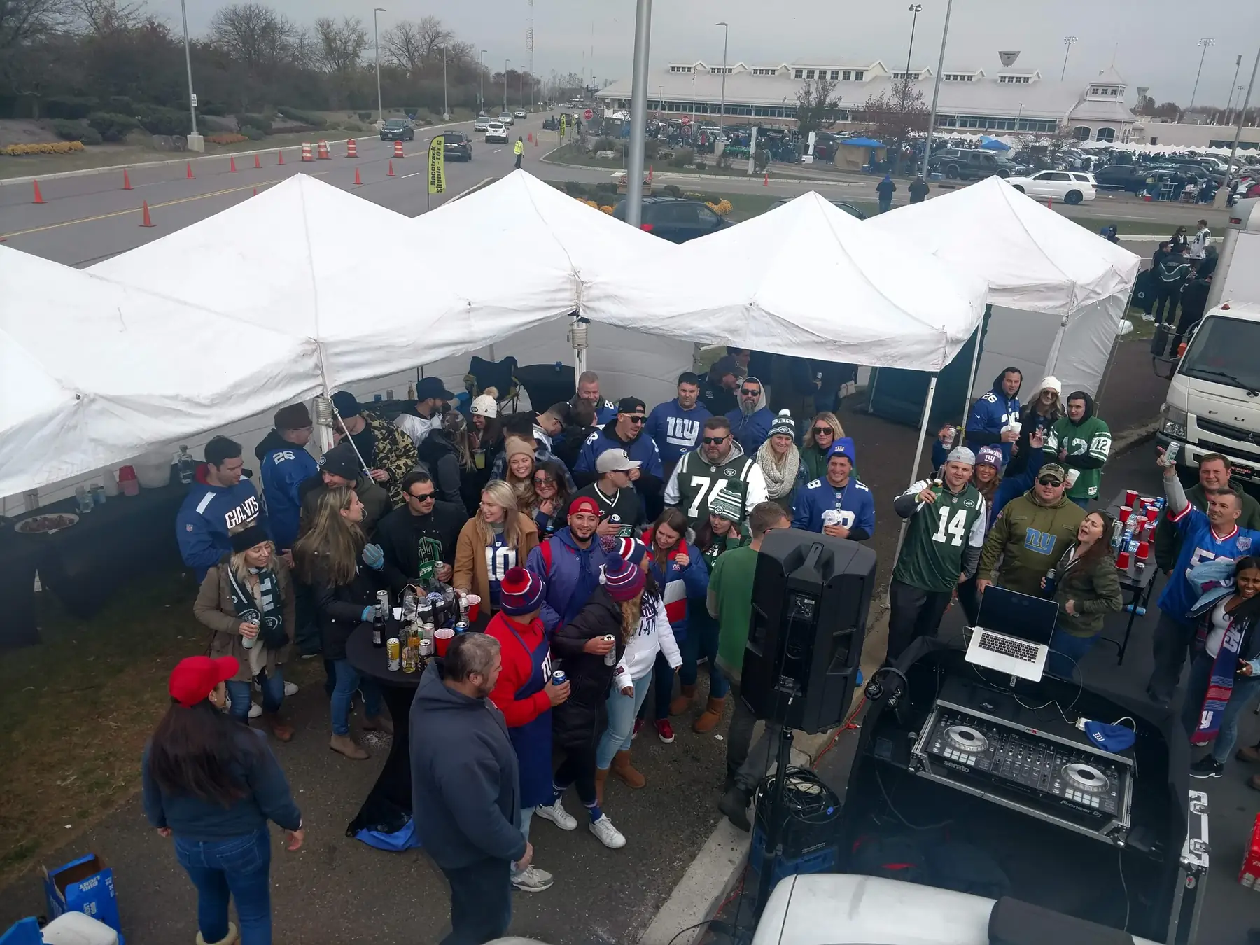 A big crowd of fans under the tents on gameday