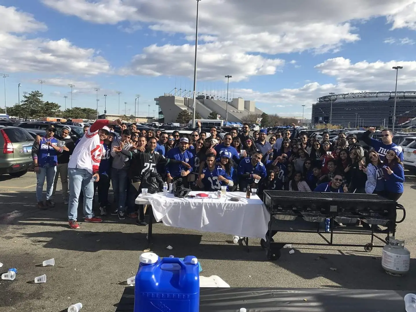 A large group gathered under the tents in the MetLife lot