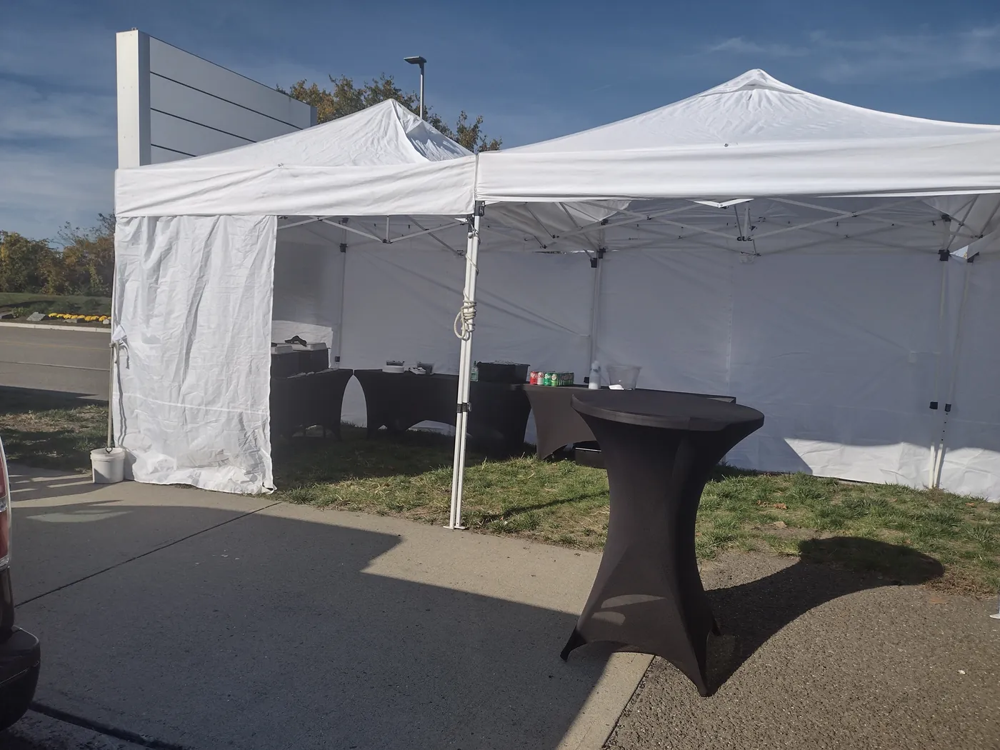 A clean catering tent and a high-top table set up