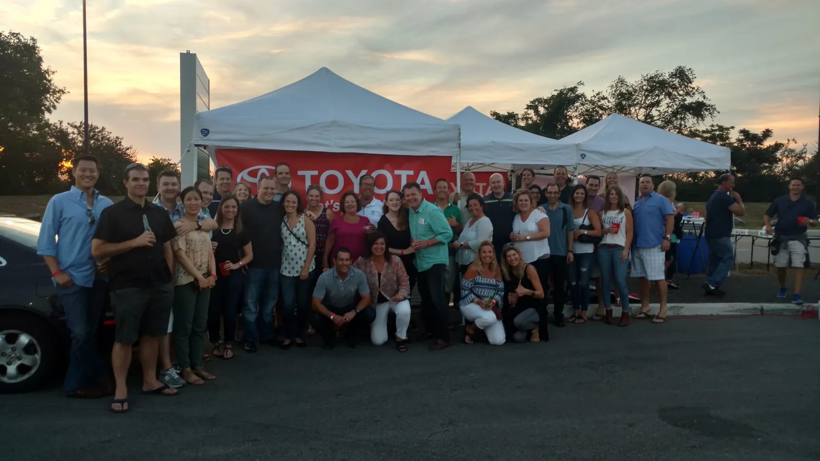 A corporate group tailgating under Gametime tents at a Toyota event